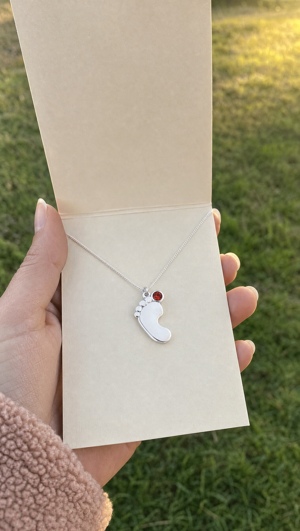 The necklace on the card it arrives on