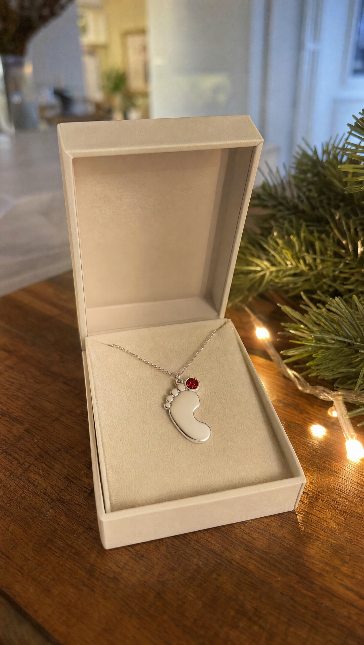 The necklace in its box beside Christmas lights